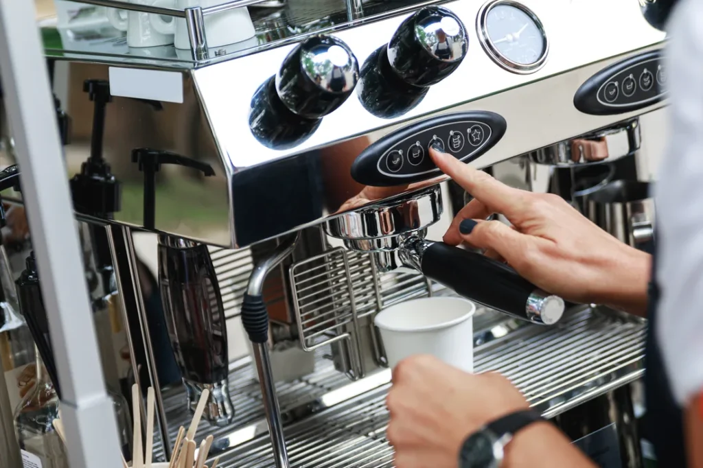 Commercial espresso machine and grinder on a mobile coffee cart