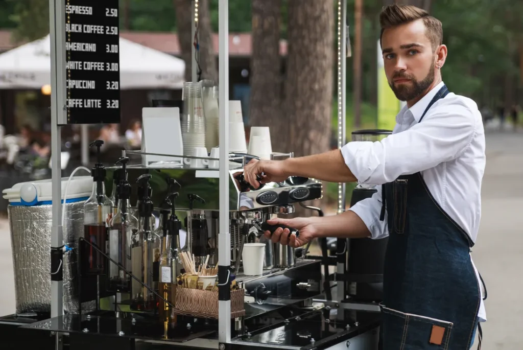Mobile coffee cart with barista and menu board at an outdoor event in Brisbane